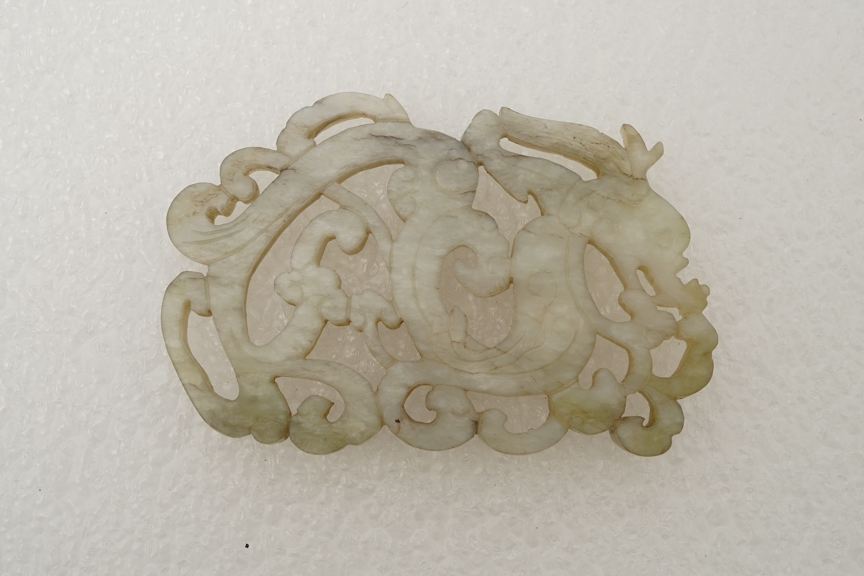 A Chinese white and grey mottled jade ‘chilong’ plaque, Ming dynasty